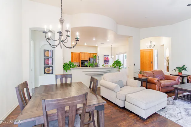 a living room with furniture chandelier and a chandelier