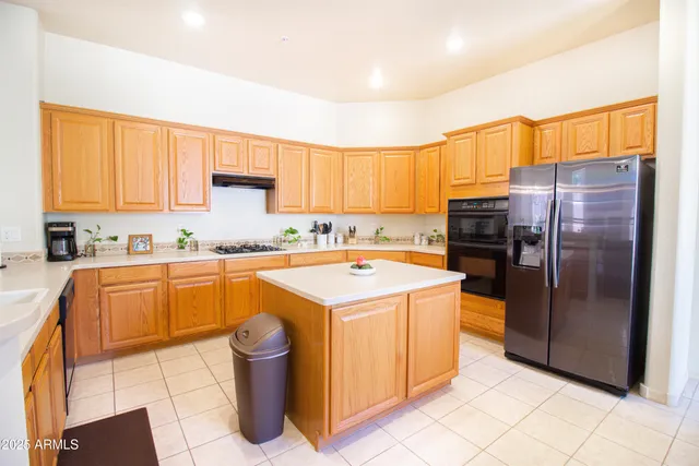 a kitchen with a refrigerator sink and cabinets