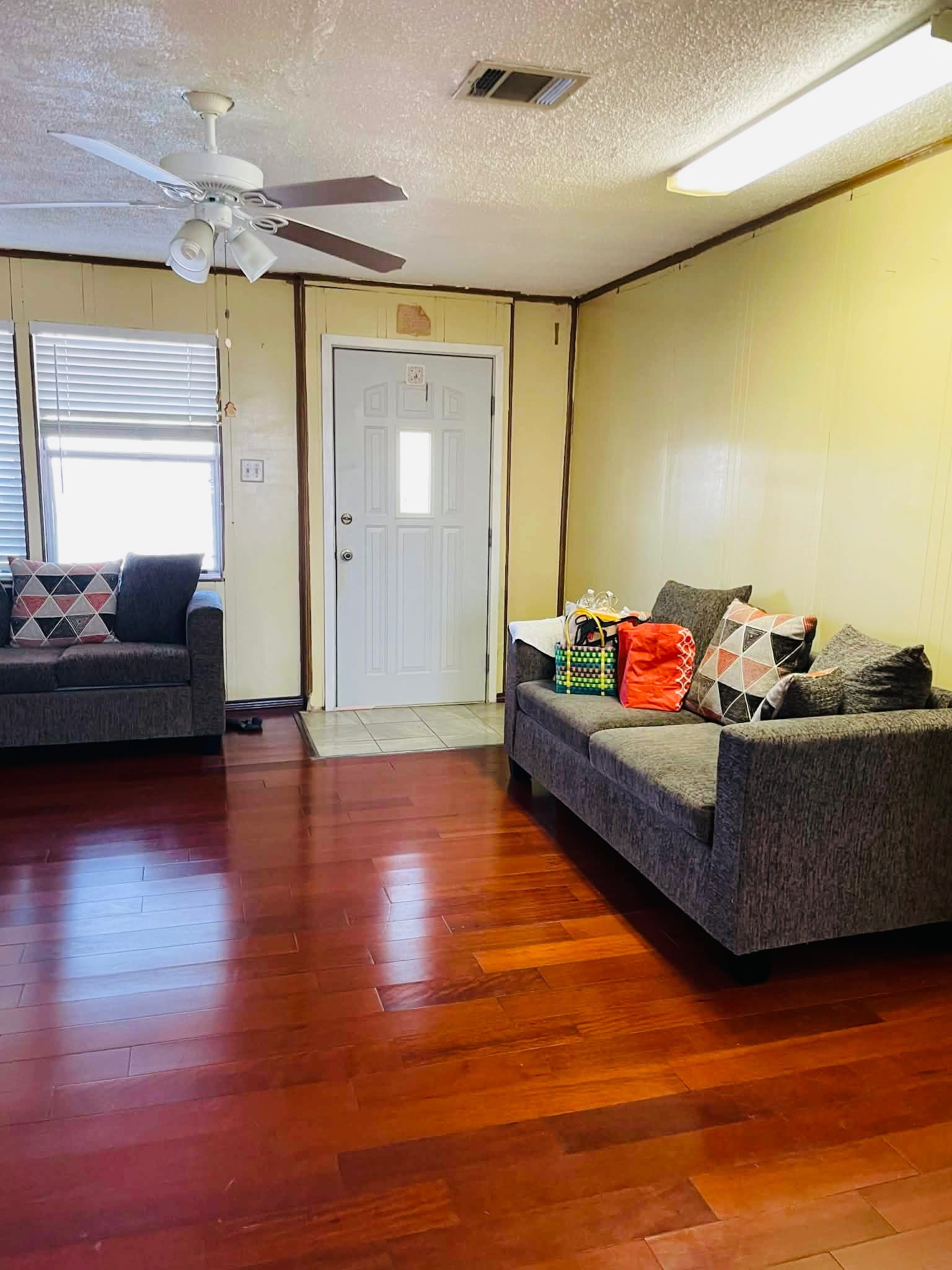 1825 Isom Street Houston, TX 77039 - Photo 12 of 27 a living room with furniture and a wooden floor