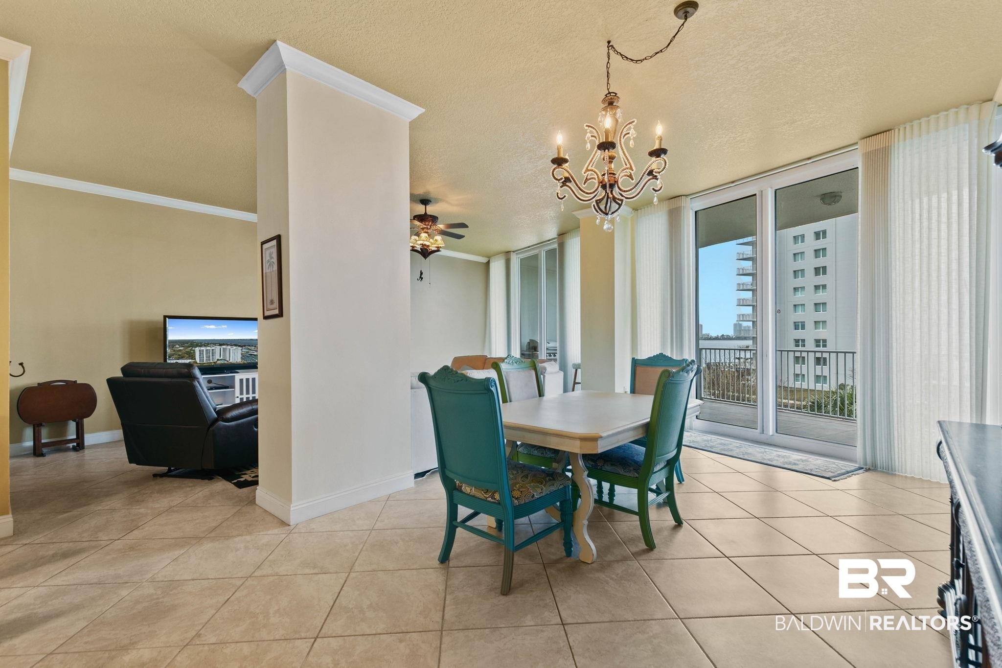 28250 Canal Road, Unit 208 Orange Beach, AL 36561 - Photo 7 of 53 Dining room with ceiling fan, suspended lighting, ornamental molding, light tile patterned floors, and a textured ceiling