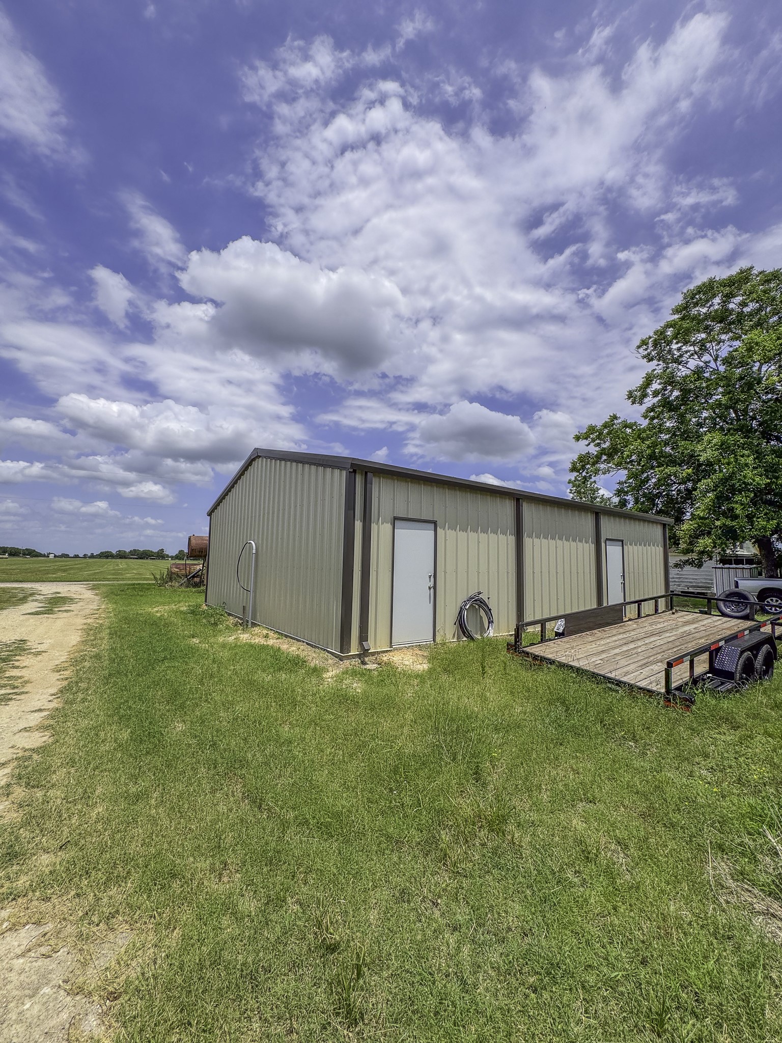 11810 Zamanek Road Needville, TX 77461 - Photo 17 of 30 a view of a house with a yard and sitting area