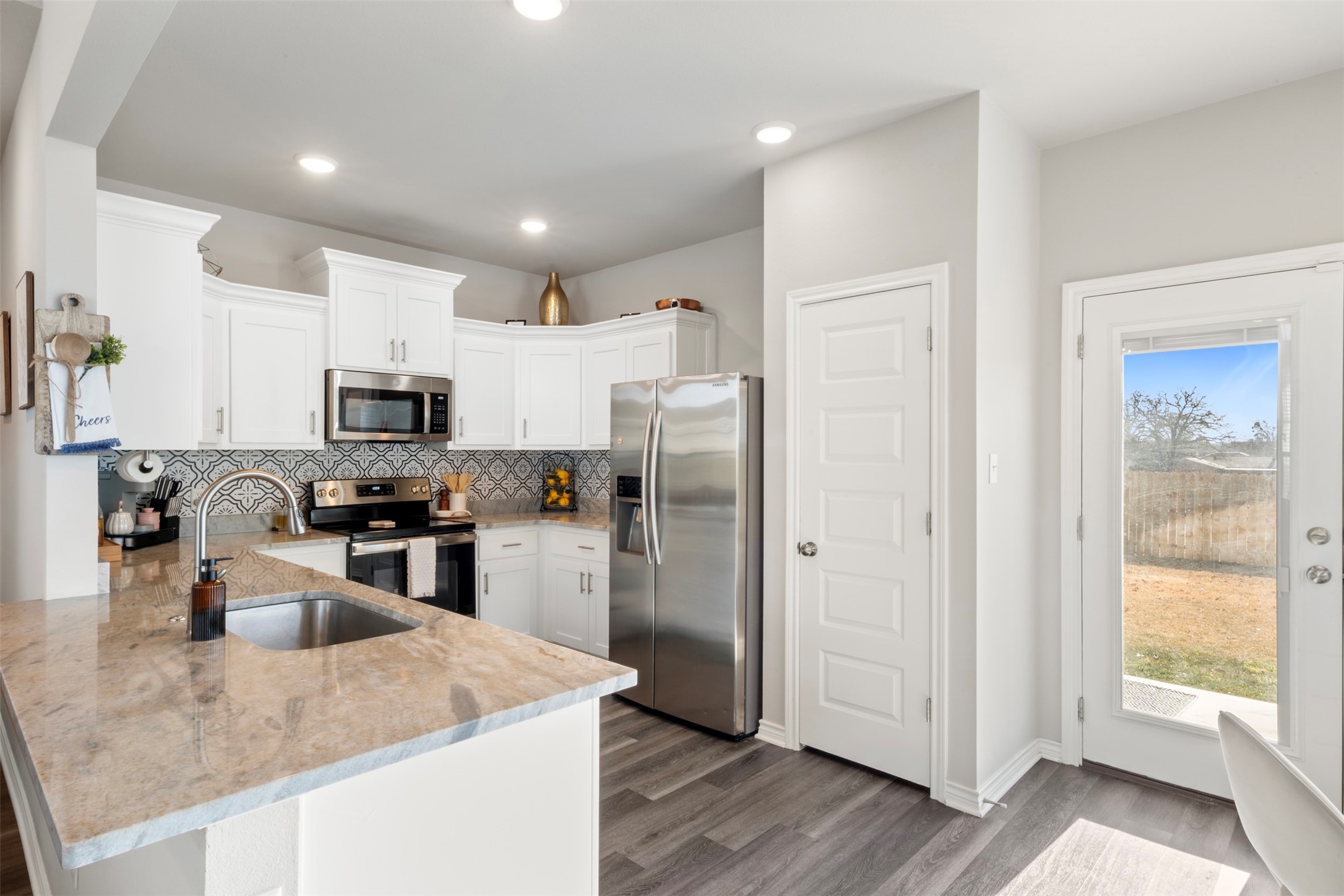 2506 Lightfoot Lane Bryan, TX 77803 - Photo 15 of 47 a kitchen with stainless steel appliances granite countertop a refrigerator a sink a stove a microwave and island