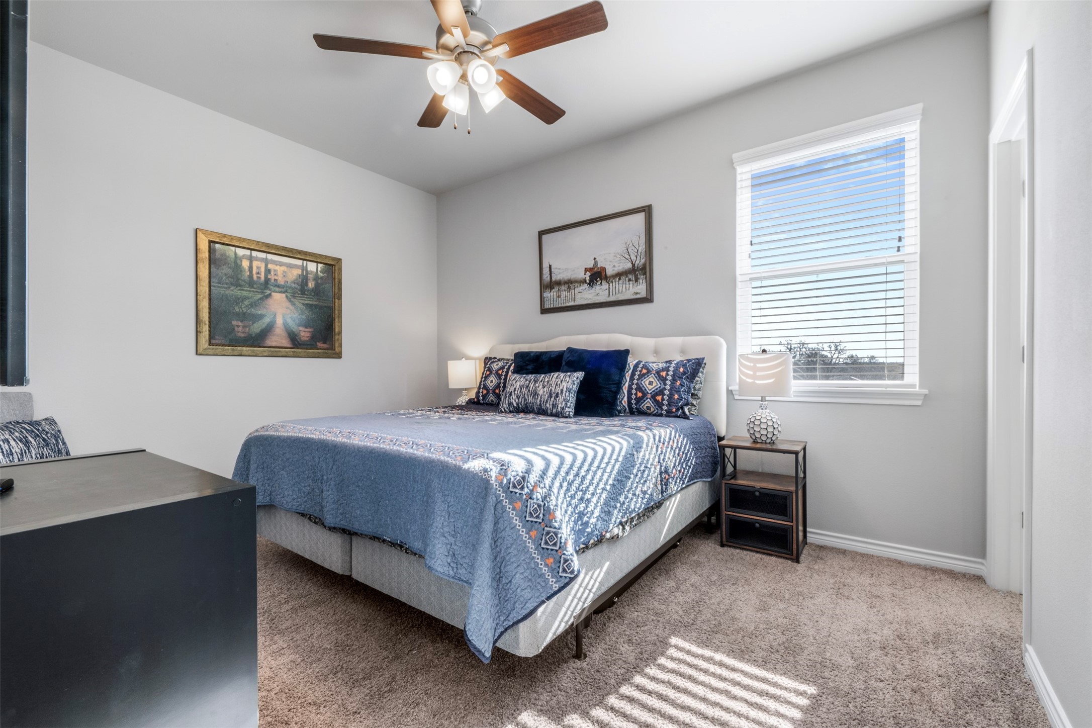 2506 Lightfoot Lane Bryan, TX 77803 - Photo 27 of 47 a bedroom with a bed and a chandelier