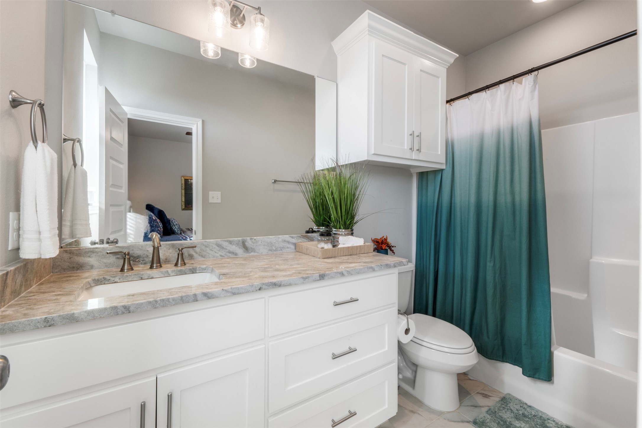 2506 Lightfoot Lane Bryan, TX 77803 - Photo 31 of 47 a bathroom with a granite countertop sink a toilet and mirror
