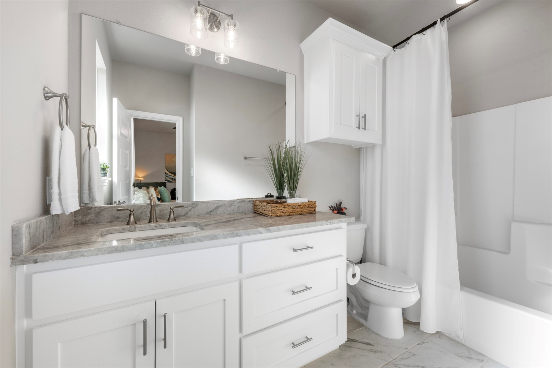 2506 Lightfoot Lane Bryan, TX 77803 - Photo 32 of 47 a bathroom with a granite countertop sink a toilet and a mirror