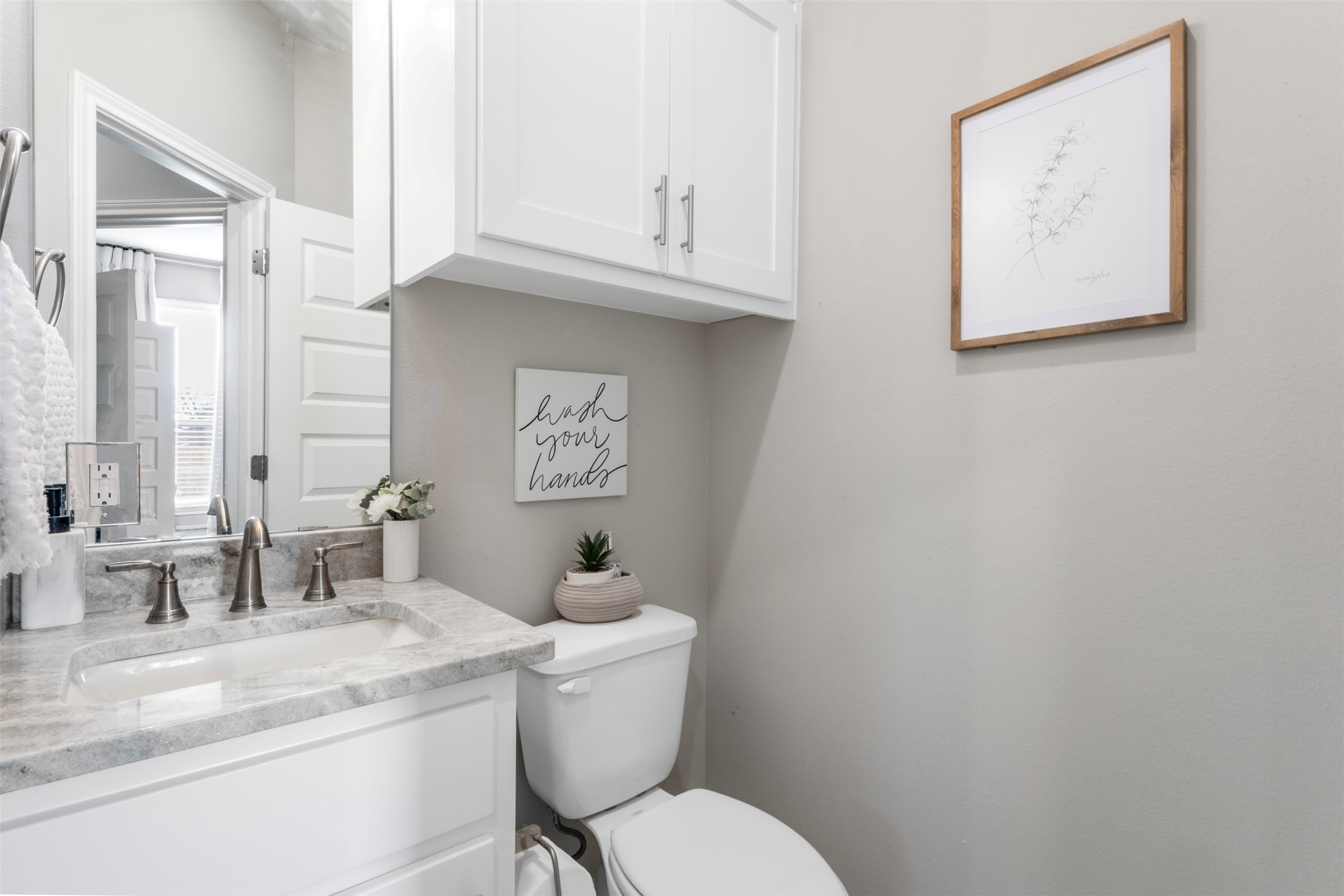 2506 Lightfoot Lane Bryan, TX 77803 - Photo 33 of 47 a bathroom with a toilet sink and mirror