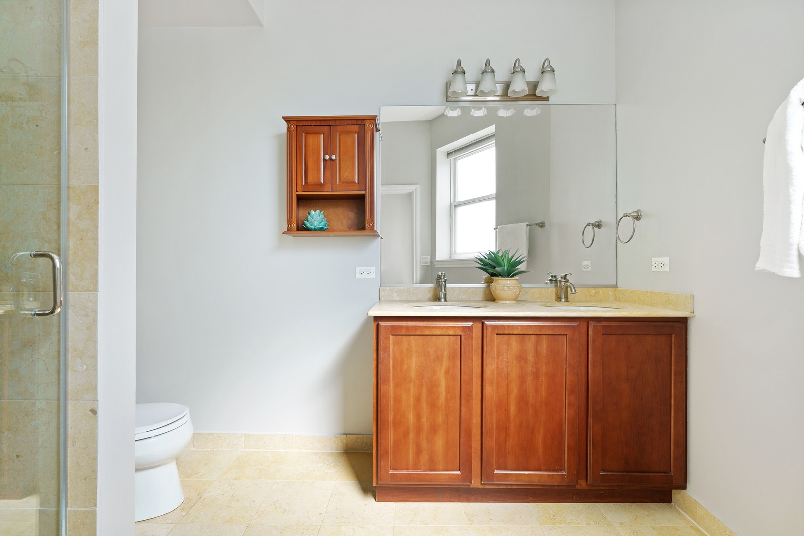 4440 North Dover Street, Unit 3S Chicago, IL 60640 - Photo 13 of 20 a bathroom with a granite countertop sink and a mirror