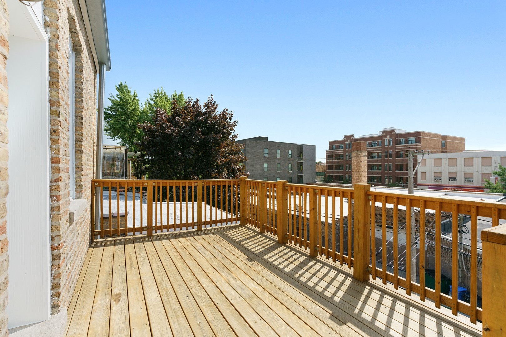 4440 North Dover Street, Unit 3S Chicago, IL 60640 - Photo 19 of 20 a view of a balcony with wooden floor and fence