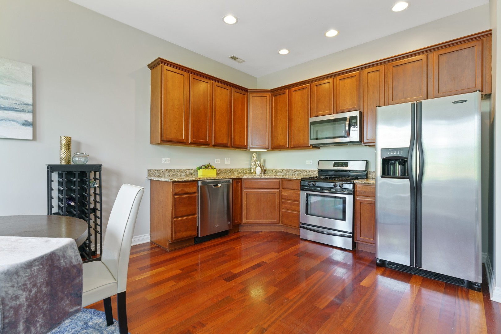 4440 North Dover Street, Unit 3S Chicago, IL 60640 - Photo 7 of 20 a kitchen with granite countertop a refrigerator stove top oven and sink