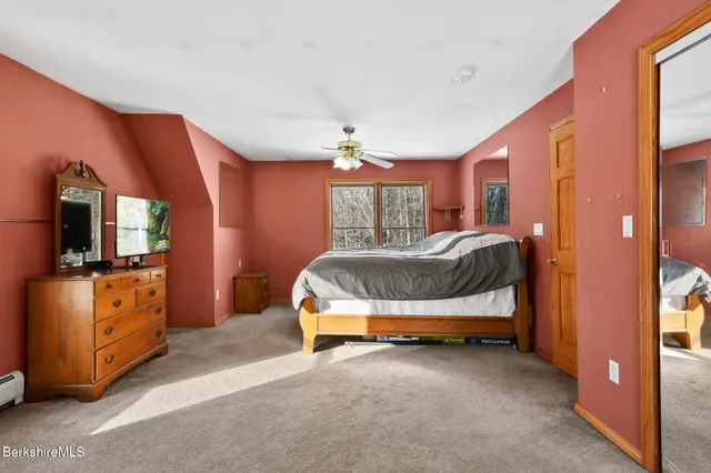 a bedroom with furniture and flat screen tv