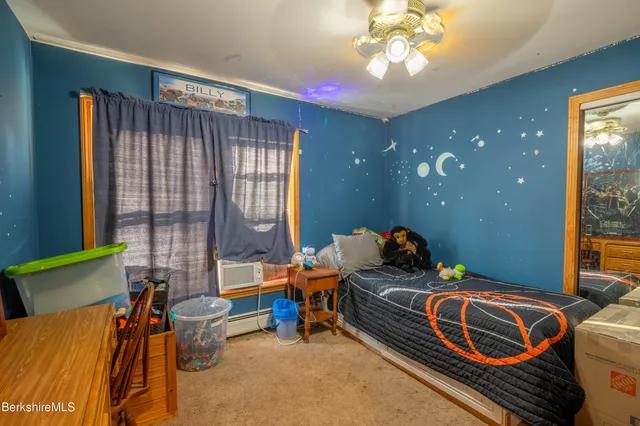 a bedroom with furniture and a window