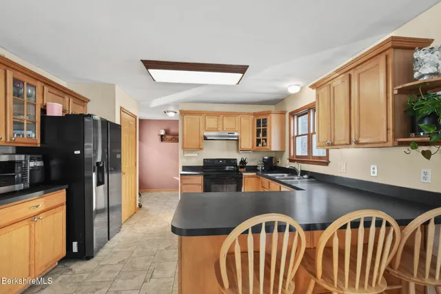 a kitchen with granite countertop lots of counter top space and stainless steel appliances