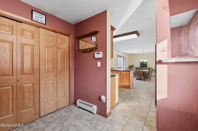 a view of a kitchen with refrigerator and cabinets