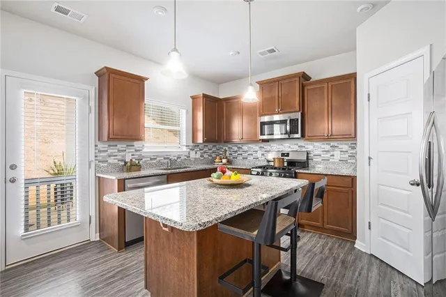 a kitchen with granite countertop a sink counter top space appliances and cabinets