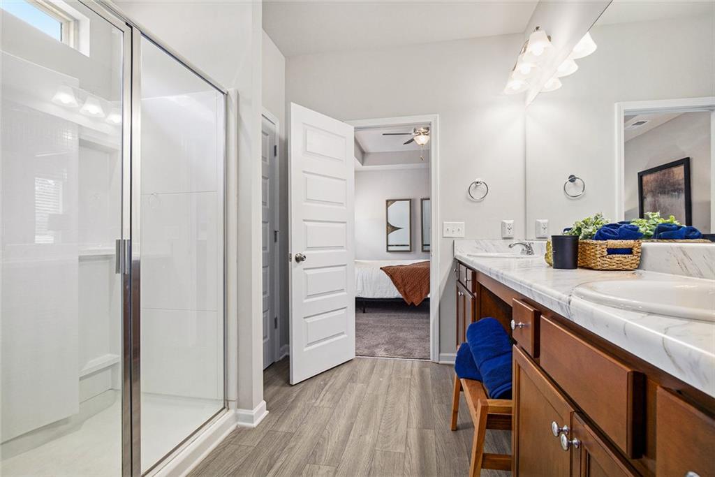 152 Malbone Street Southwest Cartersville, GA 30120 - Photo 21 of 31 a spacious bathroom with a double vanity sink a mirror and a shower
