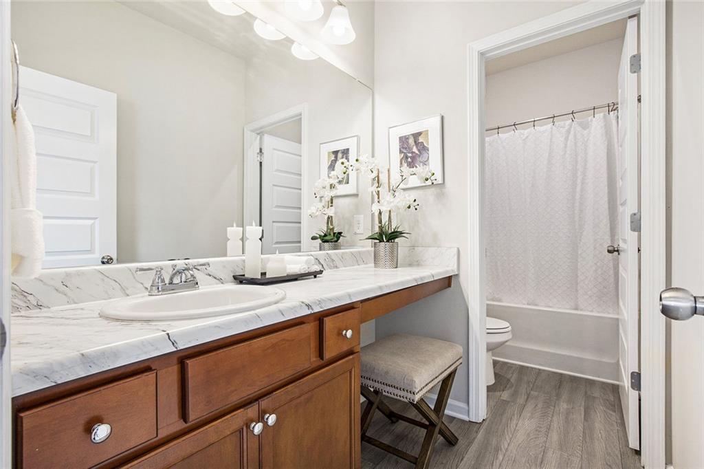 152 Malbone Street Southwest Cartersville, GA 30120 - Photo 24 of 31 a bathroom with a sink a mirror and a shower