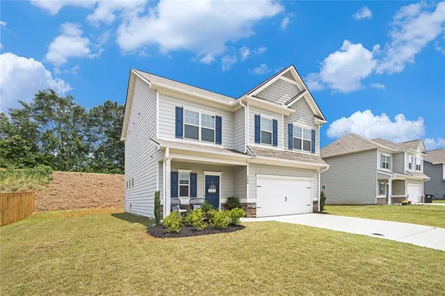 a front view of a house with a yard