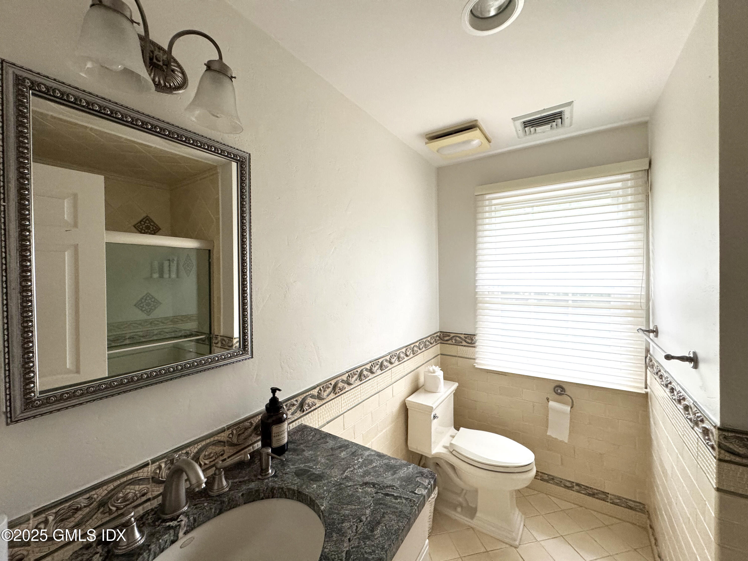 30 Split Timber Place Riverside, CT 06878 - Photo 49 of 49 a bathroom with a toilet a sink a mirror and window