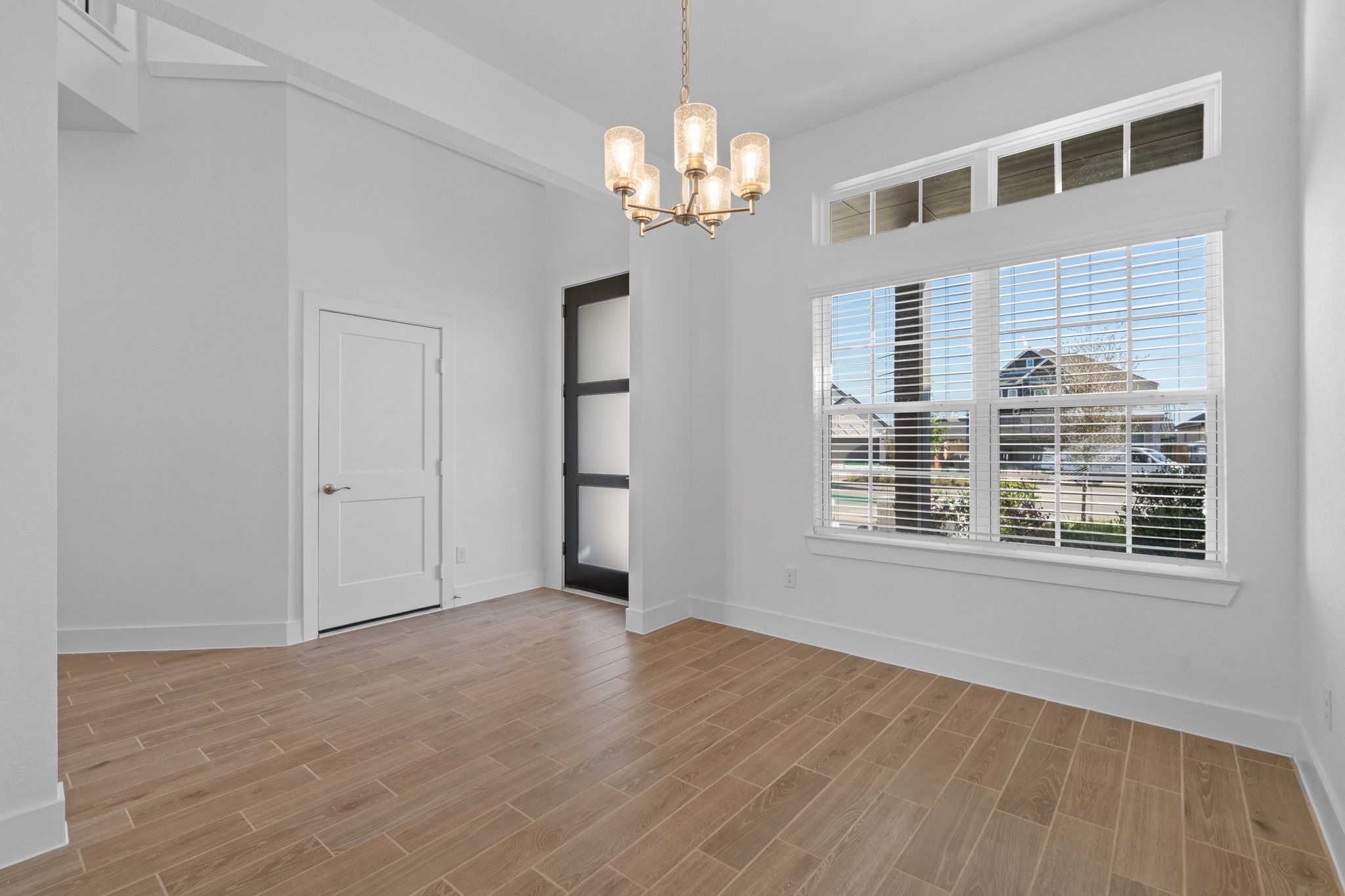 22618 Basswood Bnd Road Waller, TX 77484 - Photo 14 of 36 a view of an empty room with wooden floor and a window