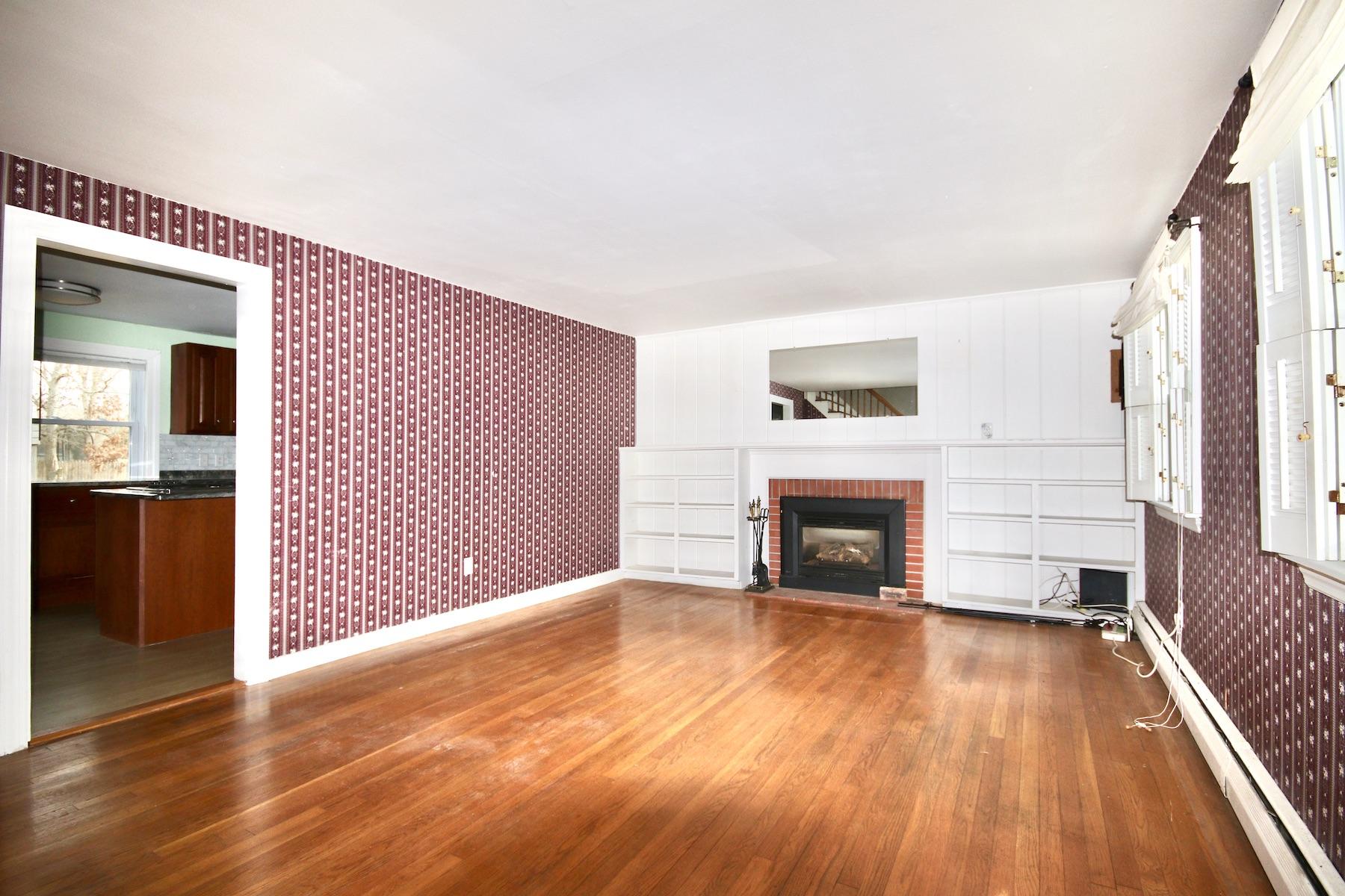 46 Fisher Road Hyannis, MA 02601 - Photo 5 of 29 a view of a livingroom with wooden floor a fireplace and entryway