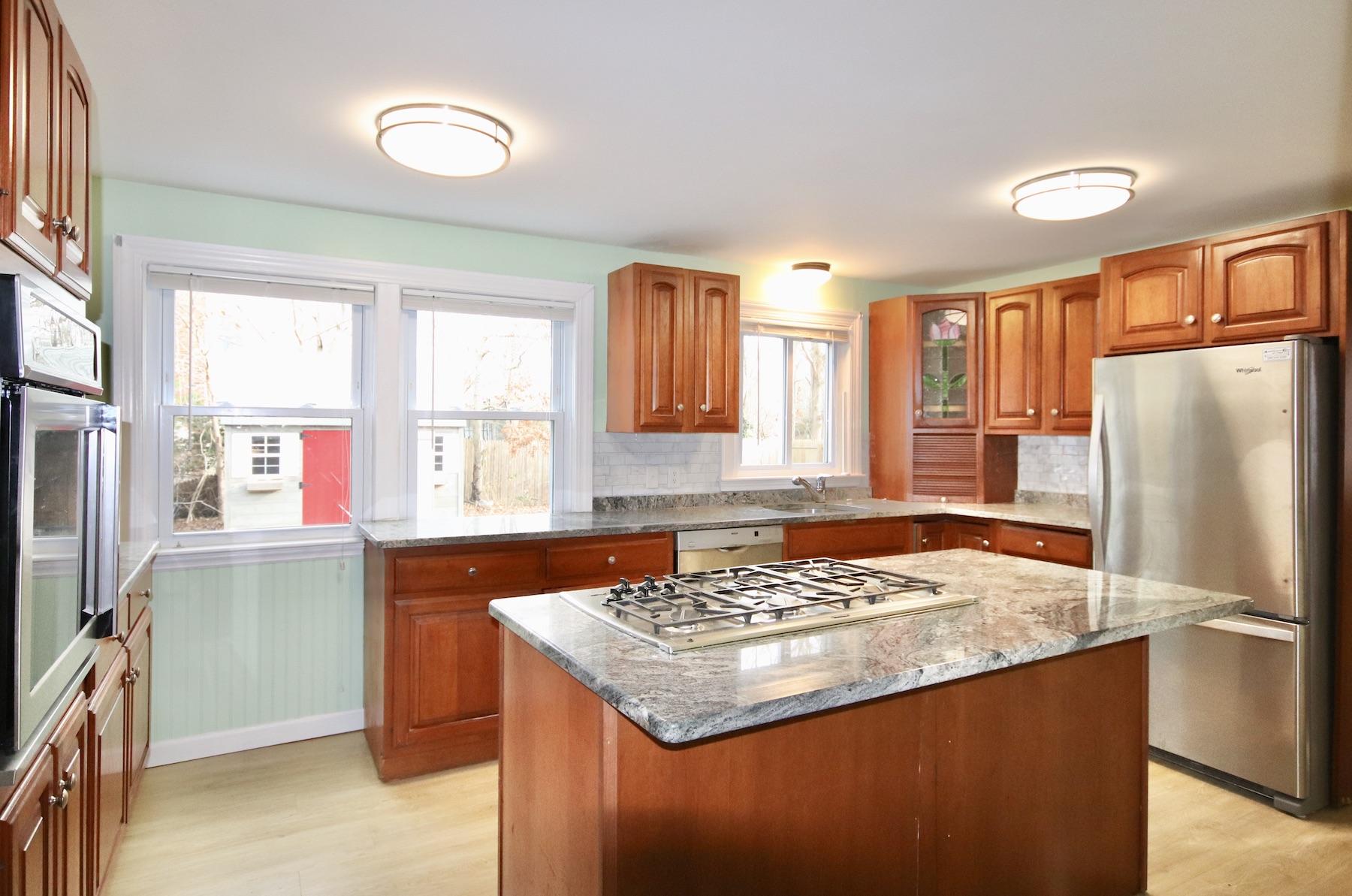 46 Fisher Road Hyannis, MA 02601 - Photo 6 of 29 a kitchen with a refrigerator a stove a sink and a window