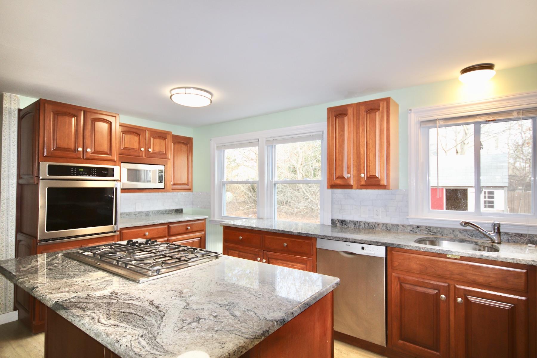 46 Fisher Road Hyannis, MA 02601 - Photo 7 of 29 a kitchen with stainless steel appliances granite countertop a sink stove and granite counter tops