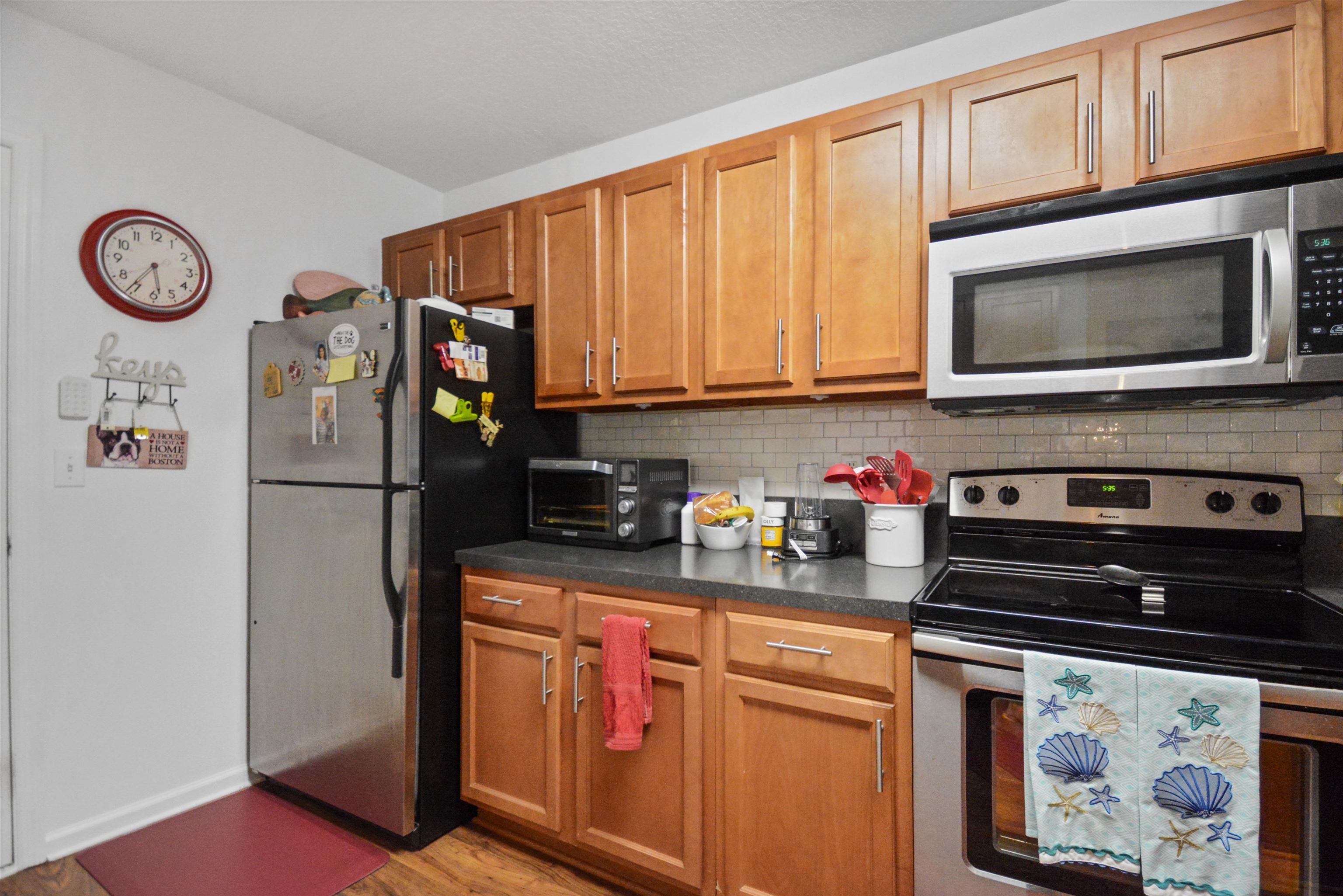 279 Buck Run Way St. Augustine, FL 32092 - Photo 11 of 28 a kitchen with stainless steel appliances granite countertop a cabinets and a stove top oven