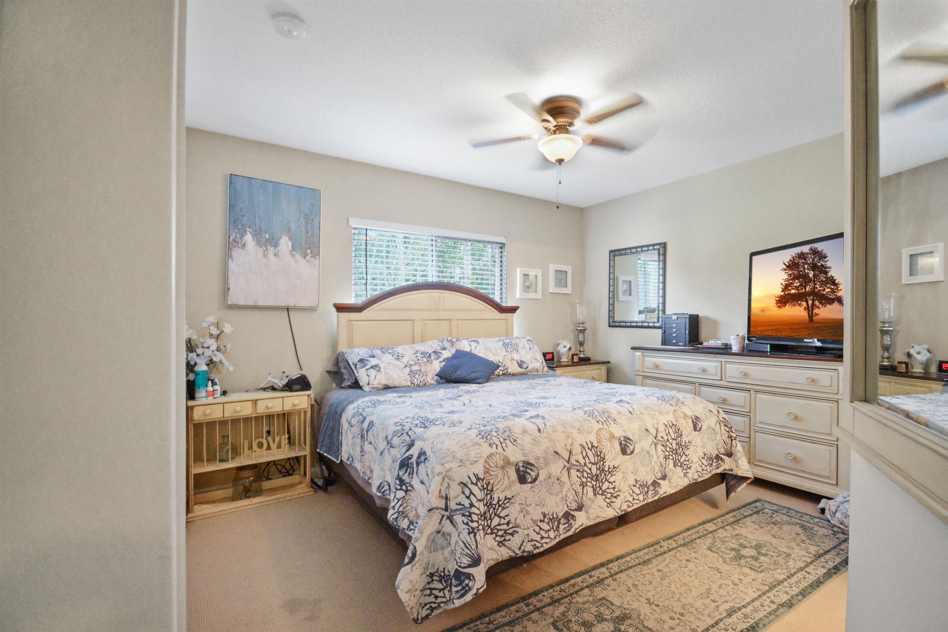 279 Buck Run Way St. Augustine, FL 32092 - Photo 12 of 28 a bedroom with a large bed and a chandelier