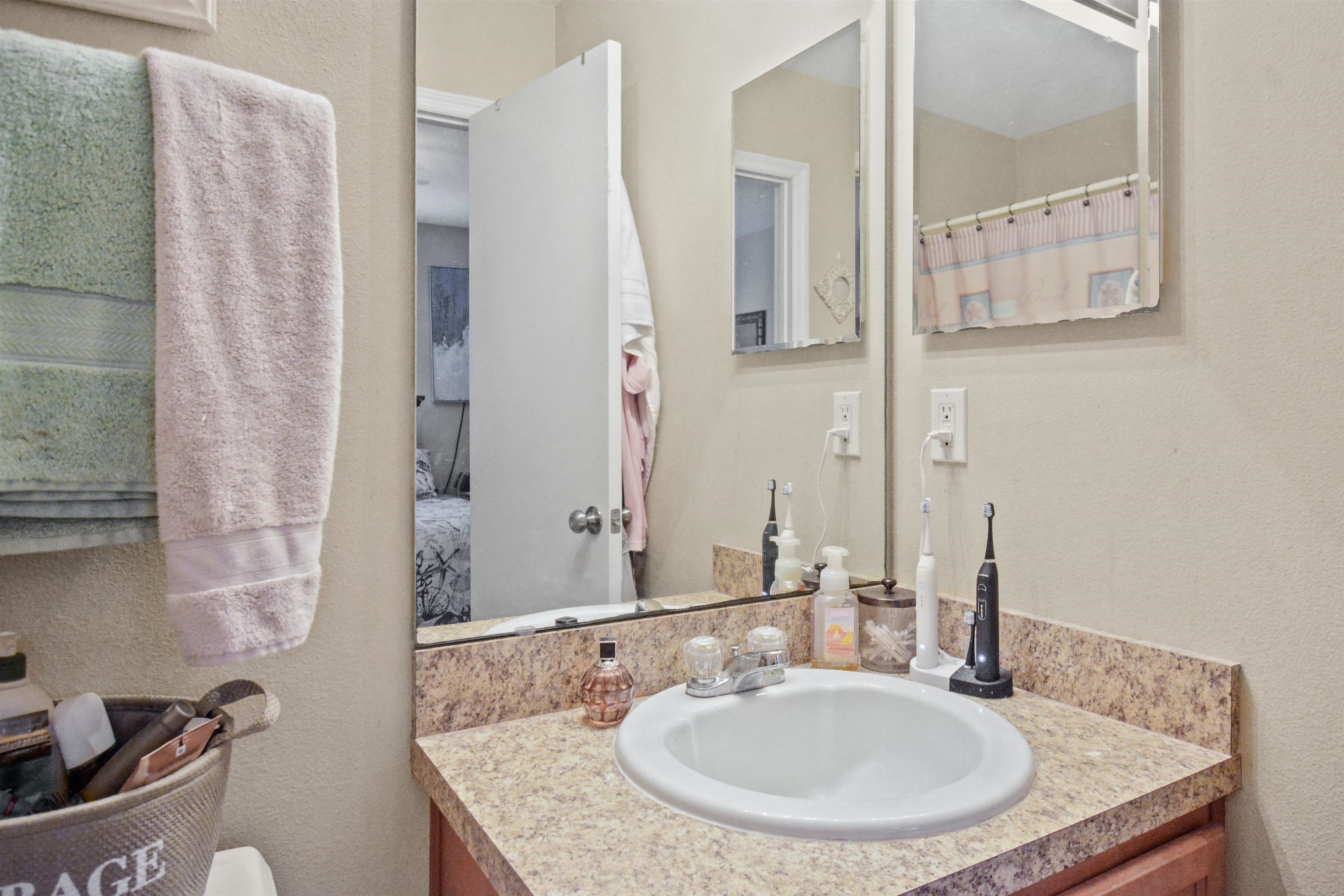 279 Buck Run Way St. Augustine, FL 32092 - Photo 15 of 28 a bathroom with a granite countertop sink and a mirror