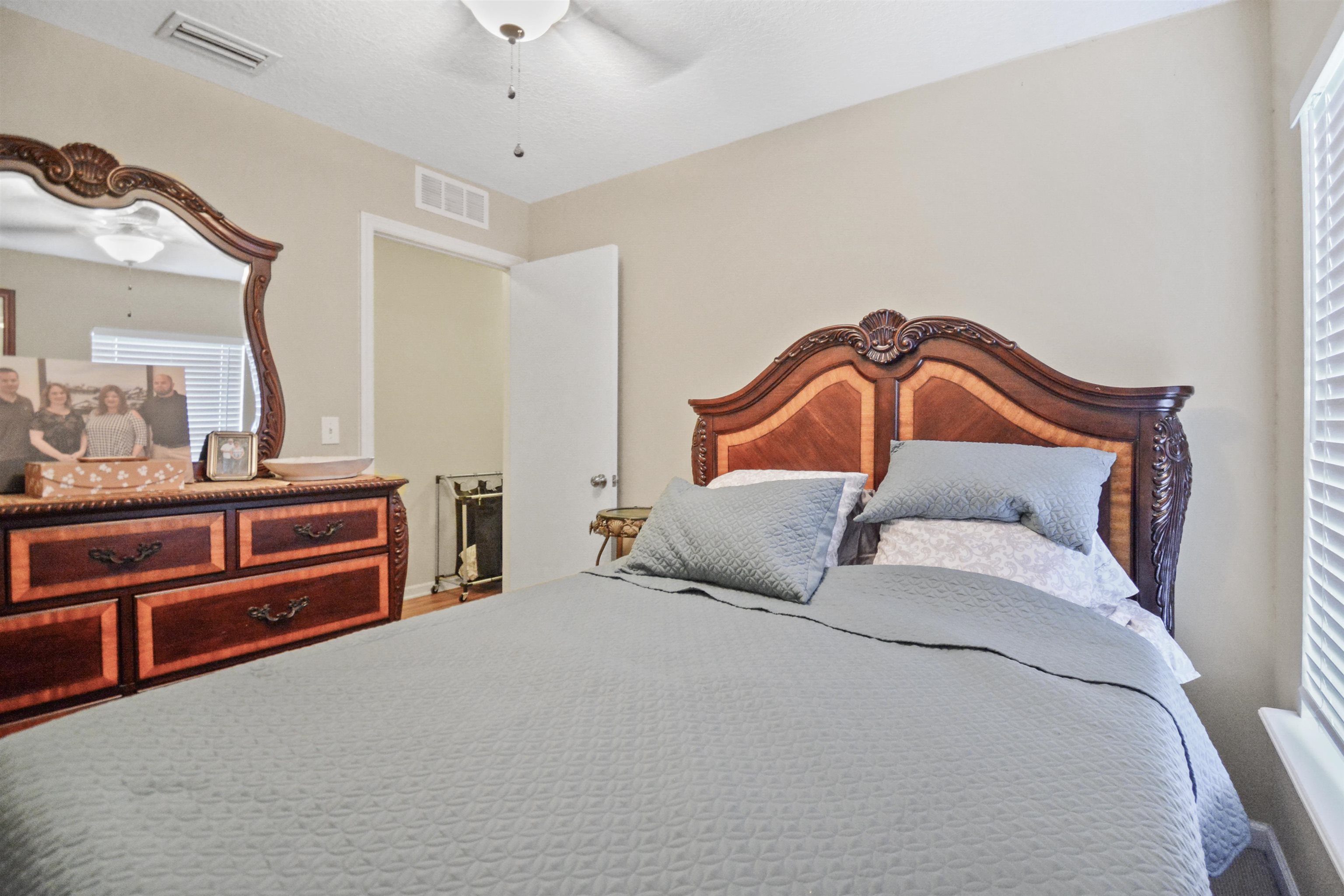279 Buck Run Way St. Augustine, FL 32092 - Photo 18 of 28 a bedroom with a bed and ceiling fan