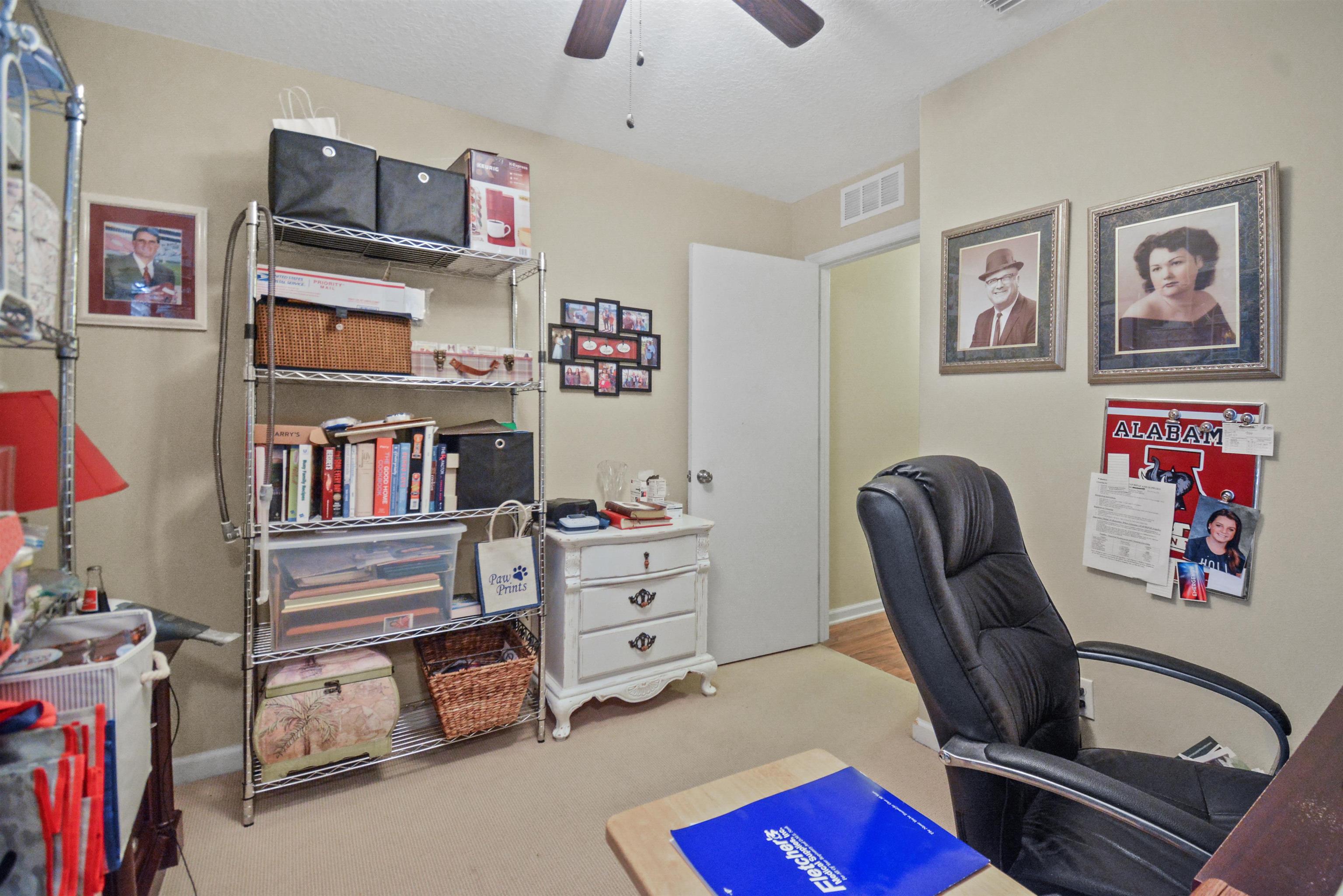 279 Buck Run Way St. Augustine, FL 32092 - Photo 20 of 28 a bedroom with furniture and a book shelf