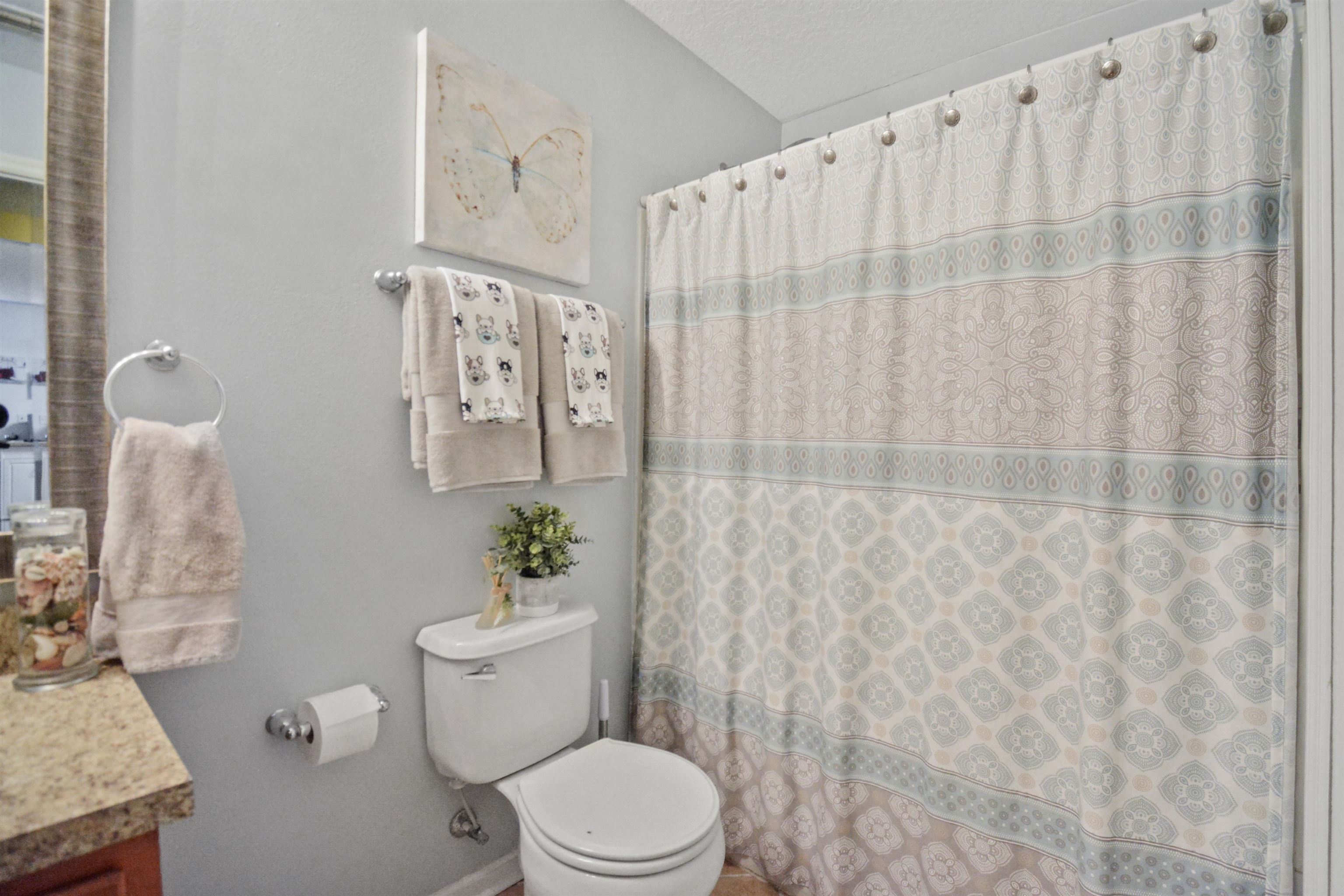 279 Buck Run Way St. Augustine, FL 32092 - Photo 21 of 28 a white toilet sitting next to a shower curtain