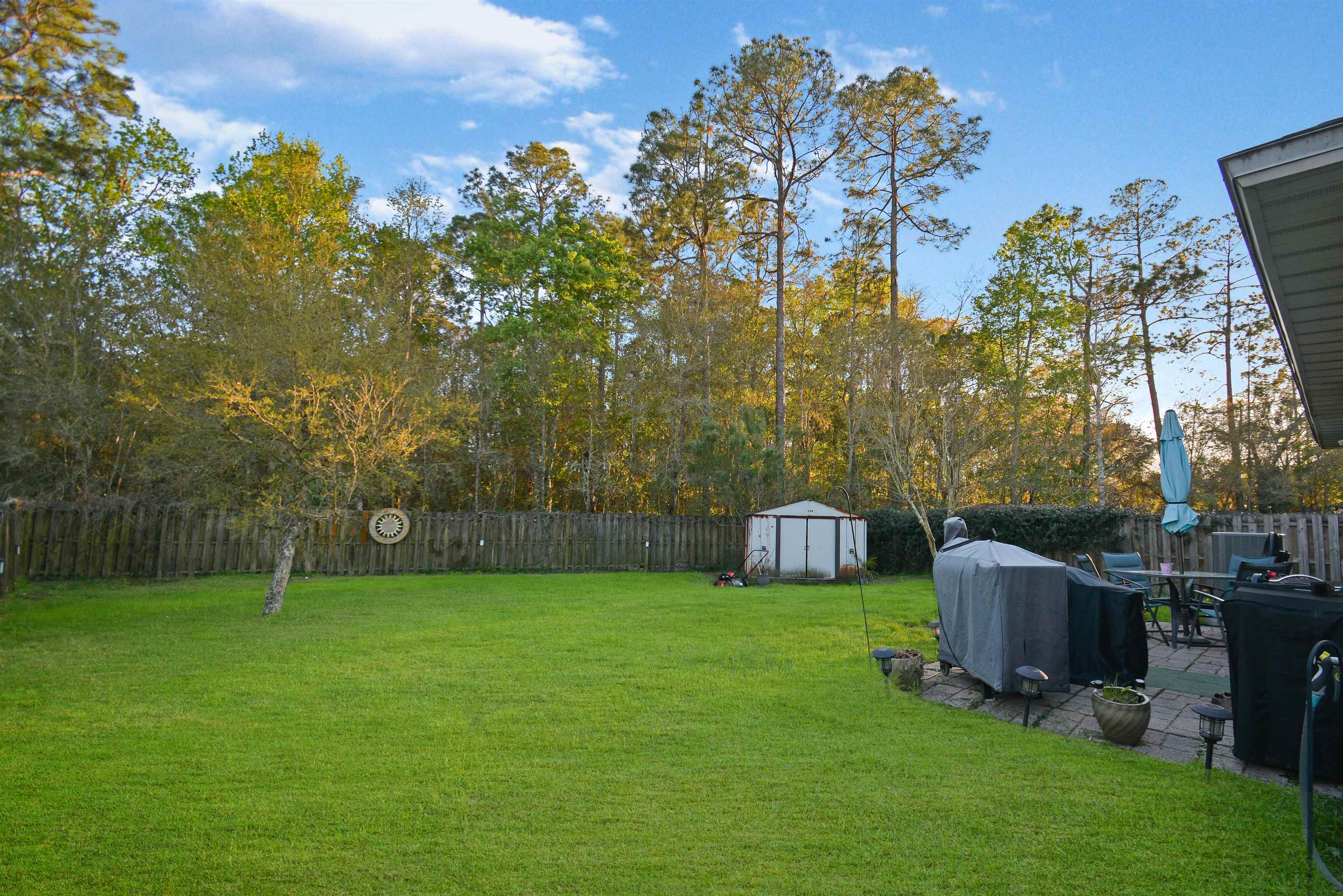 279 Buck Run Way St. Augustine, FL 32092 - Photo 23 of 28 a view of a chairs and table in the garden