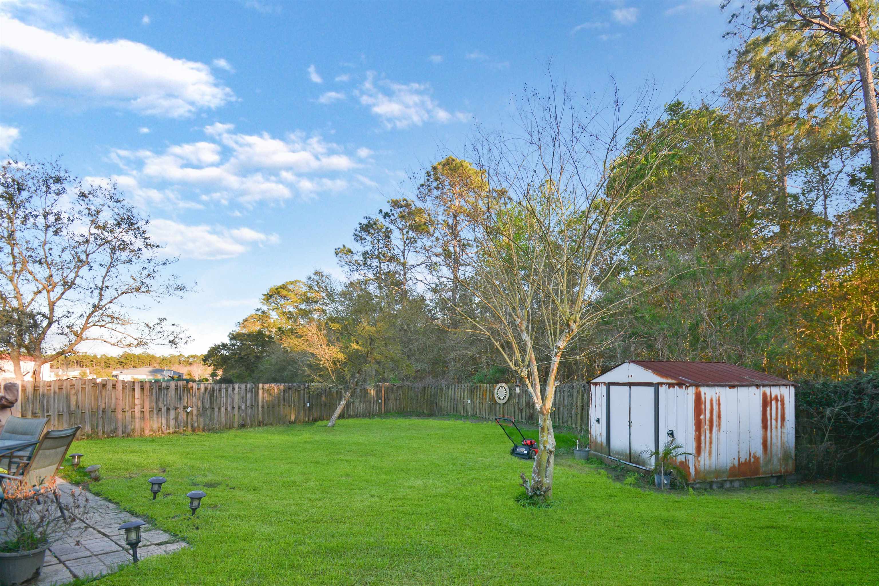 279 Buck Run Way St. Augustine, FL 32092 - Photo 26 of 28 a view of yard with green space and wooden fence