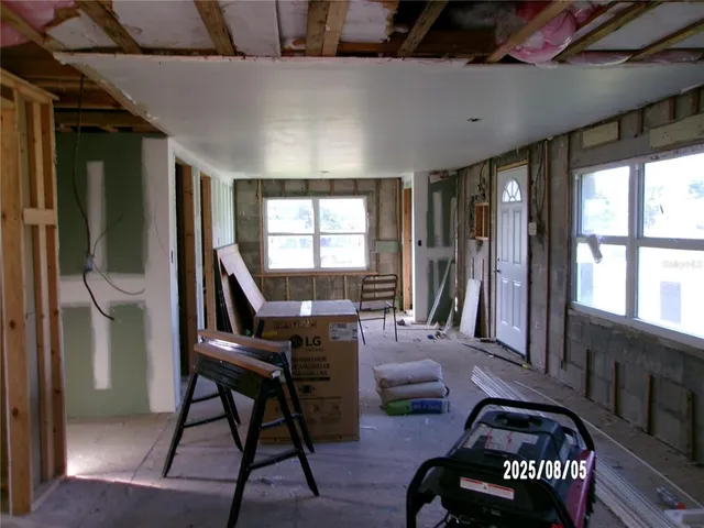 a living room with furniture and a floor to ceiling window