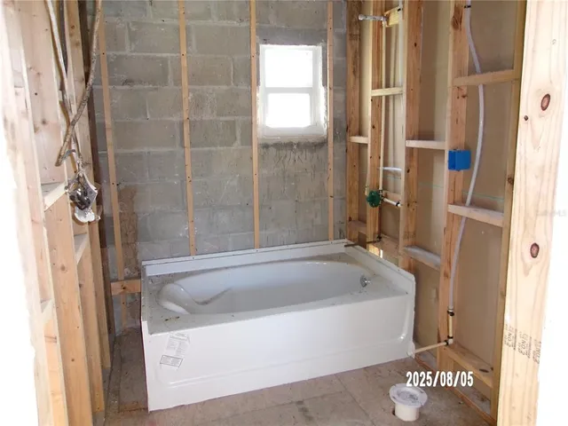 a bathroom with a bathtub and a shower