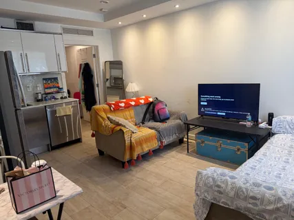 a bedroom with furniture and a flat screen tv