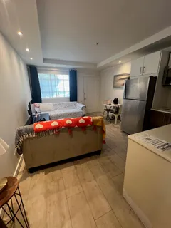 a bedroom with a bed and a refrigerator