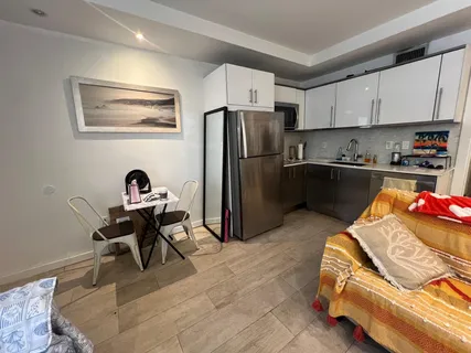 a kitchen with stainless steel appliances kitchen island granite countertop a refrigerator and a stove top oven