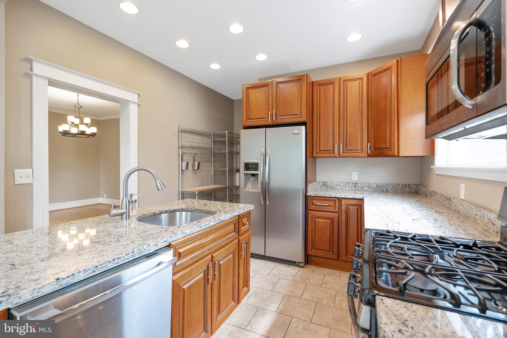 1955 Seminary Road Silver Spring, MD 20910 - Photo 12 of 41 a kitchen with stainless steel appliances granite countertop a sink stove and refrigerator