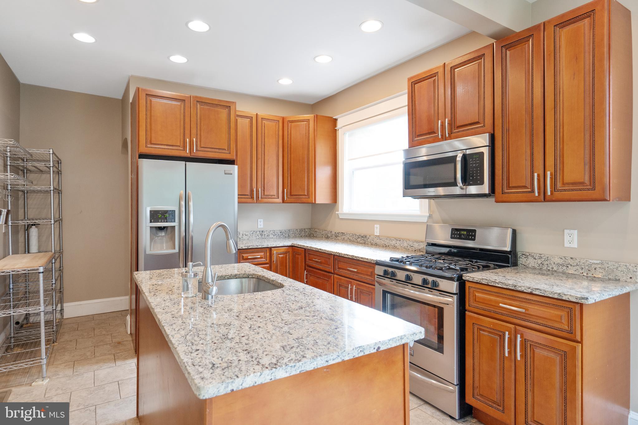 1955 Seminary Road Silver Spring, MD 20910 - Photo 13 of 41 a kitchen with stainless steel appliances granite countertop a sink a stove and a microwave