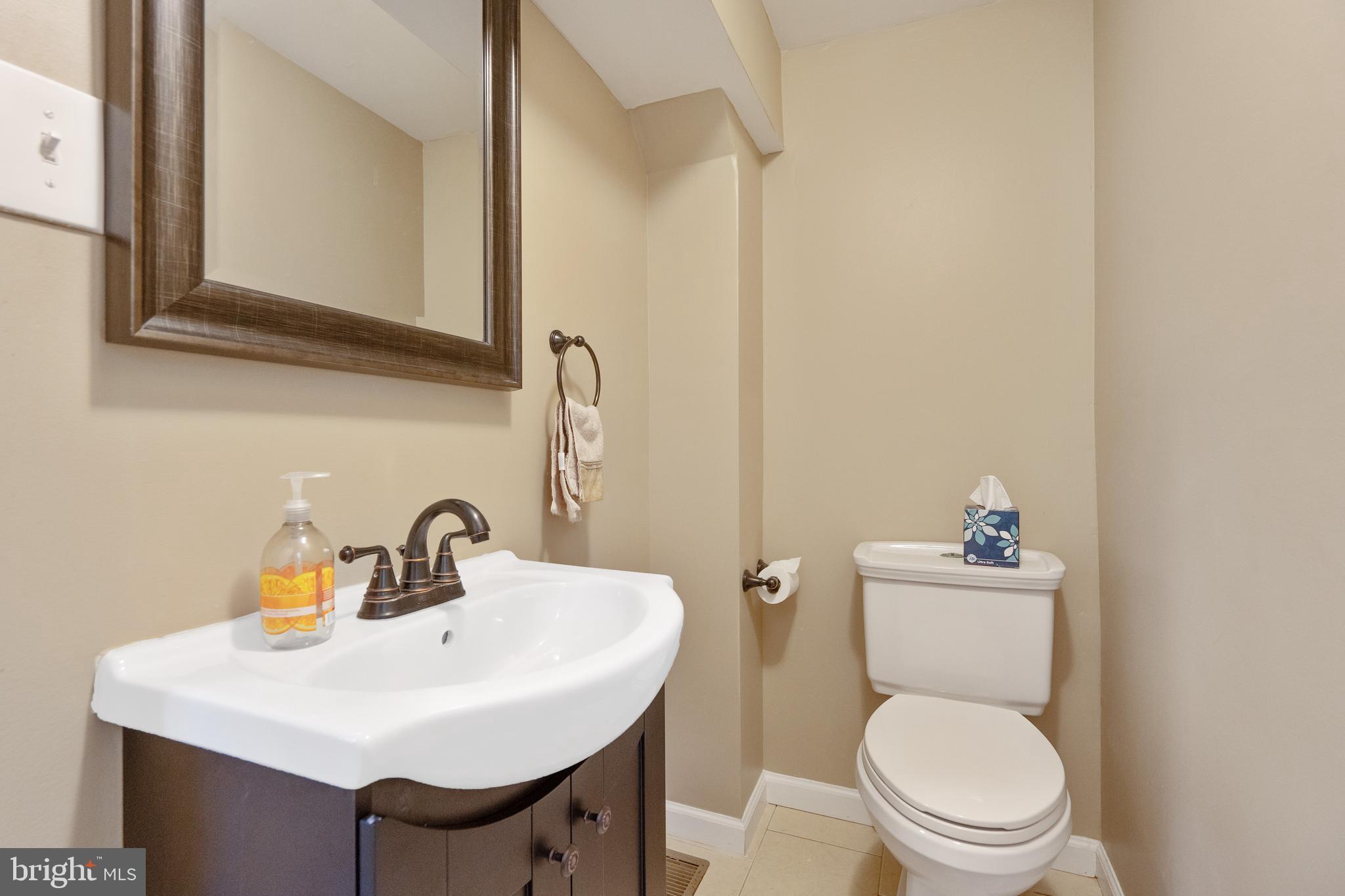 1955 Seminary Road Silver Spring, MD 20910 - Photo 16 of 41 a bathroom with a toilet a sink and a mirror