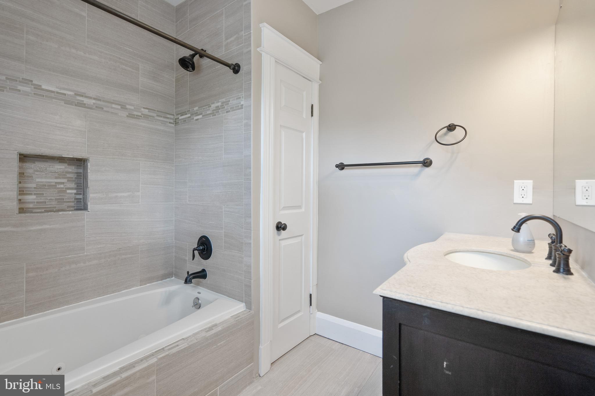 1955 Seminary Road Silver Spring, MD 20910 - Photo 20 of 41 a bathroom with a tub sink vanity and mirror