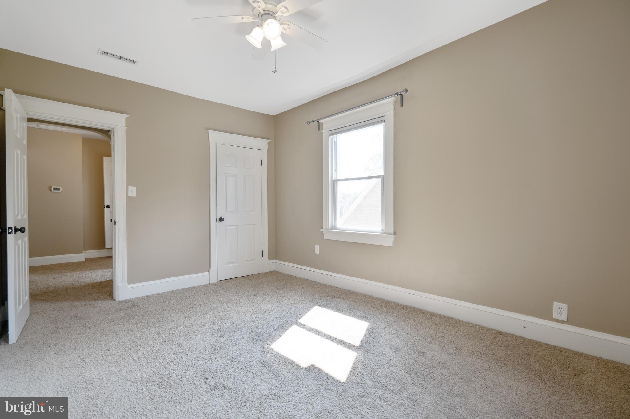 1955 Seminary Road Silver Spring, MD 20910 - Photo 22 of 41 wooden floor in an empty room with a window