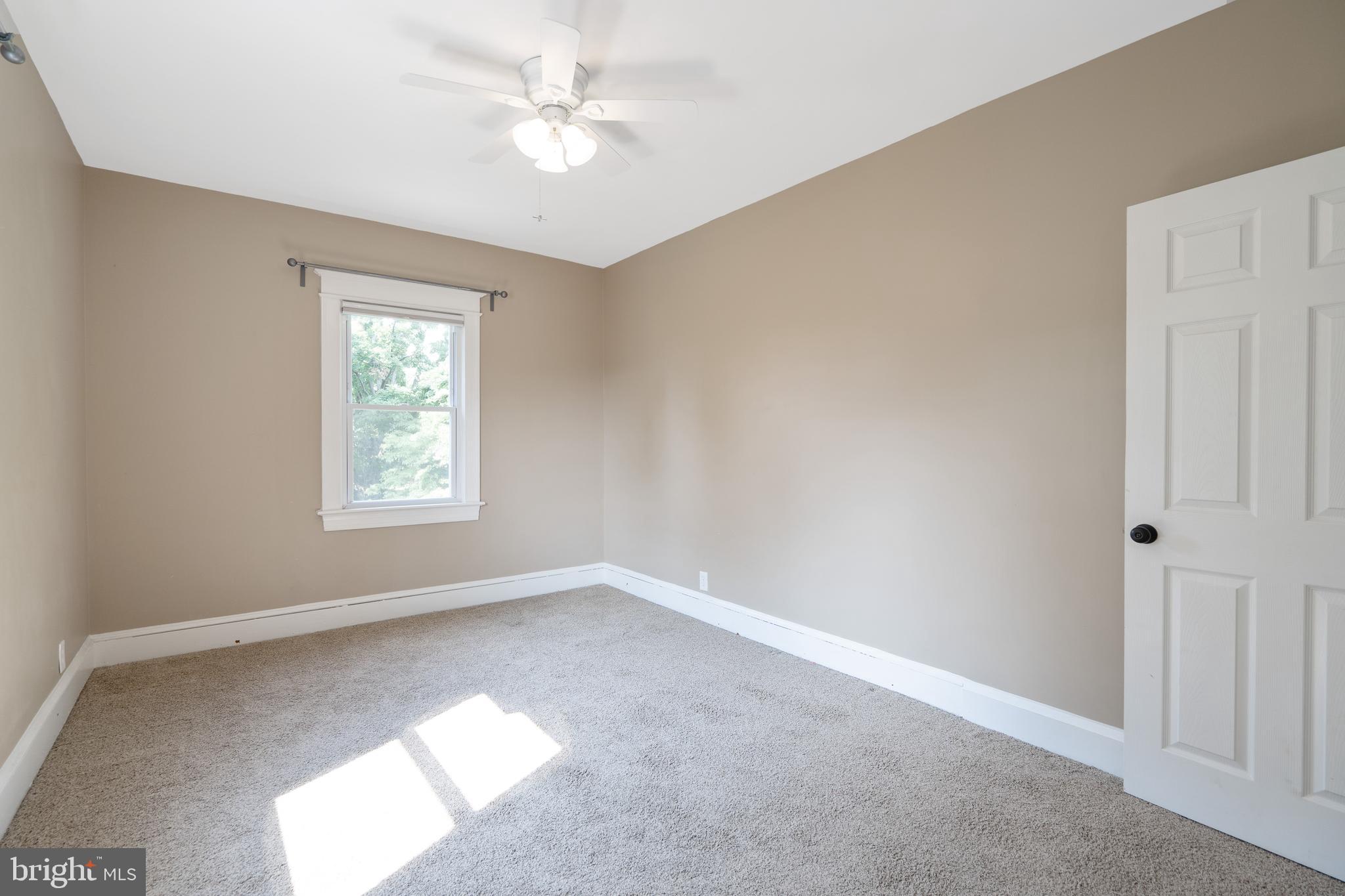 1955 Seminary Road Silver Spring, MD 20910 - Photo 25 of 41 an empty room with a window and a fan