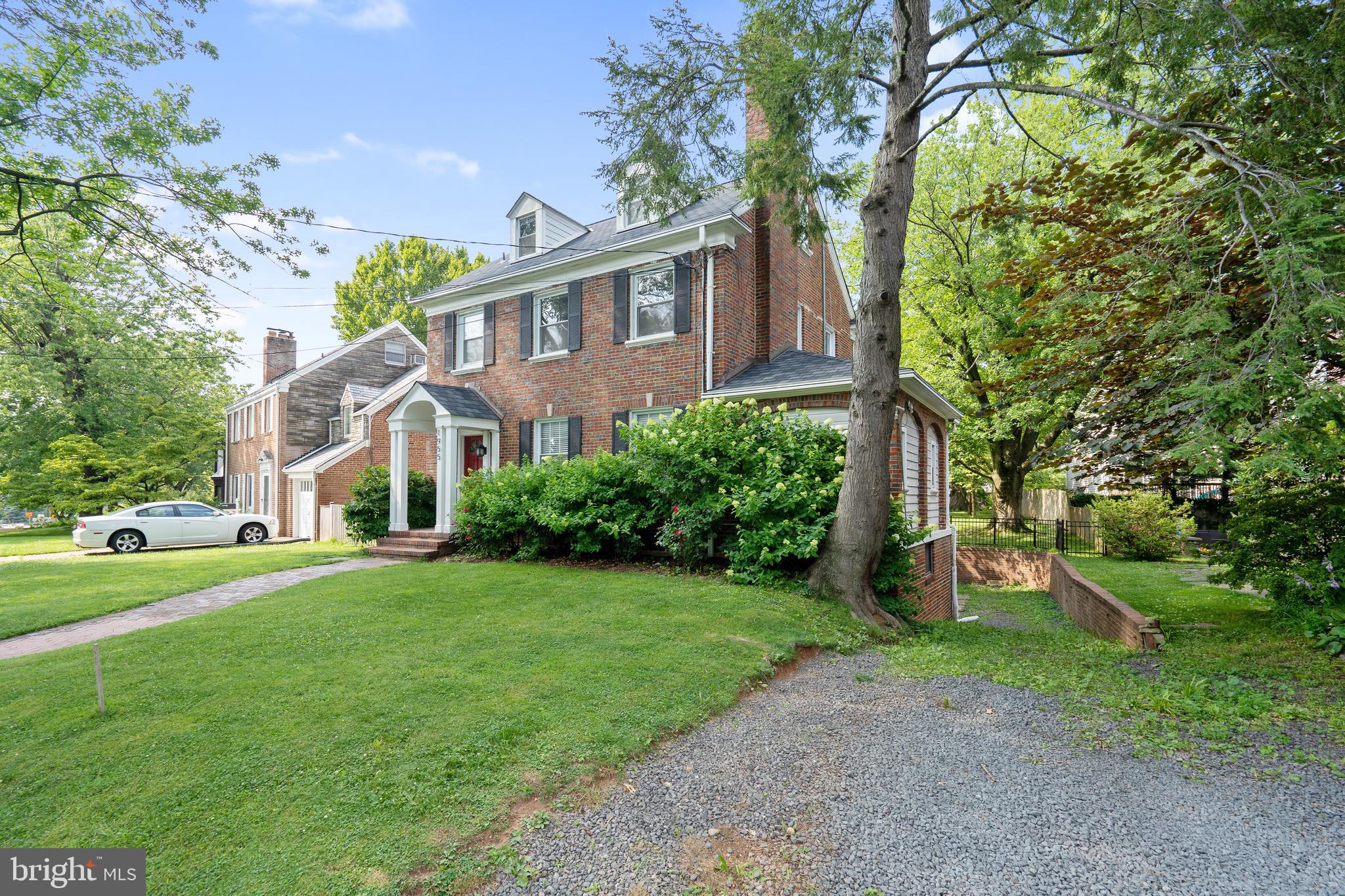 1955 Seminary Road Silver Spring, MD 20910 - Photo 3 of 41 a front view of a house with a yard and trees