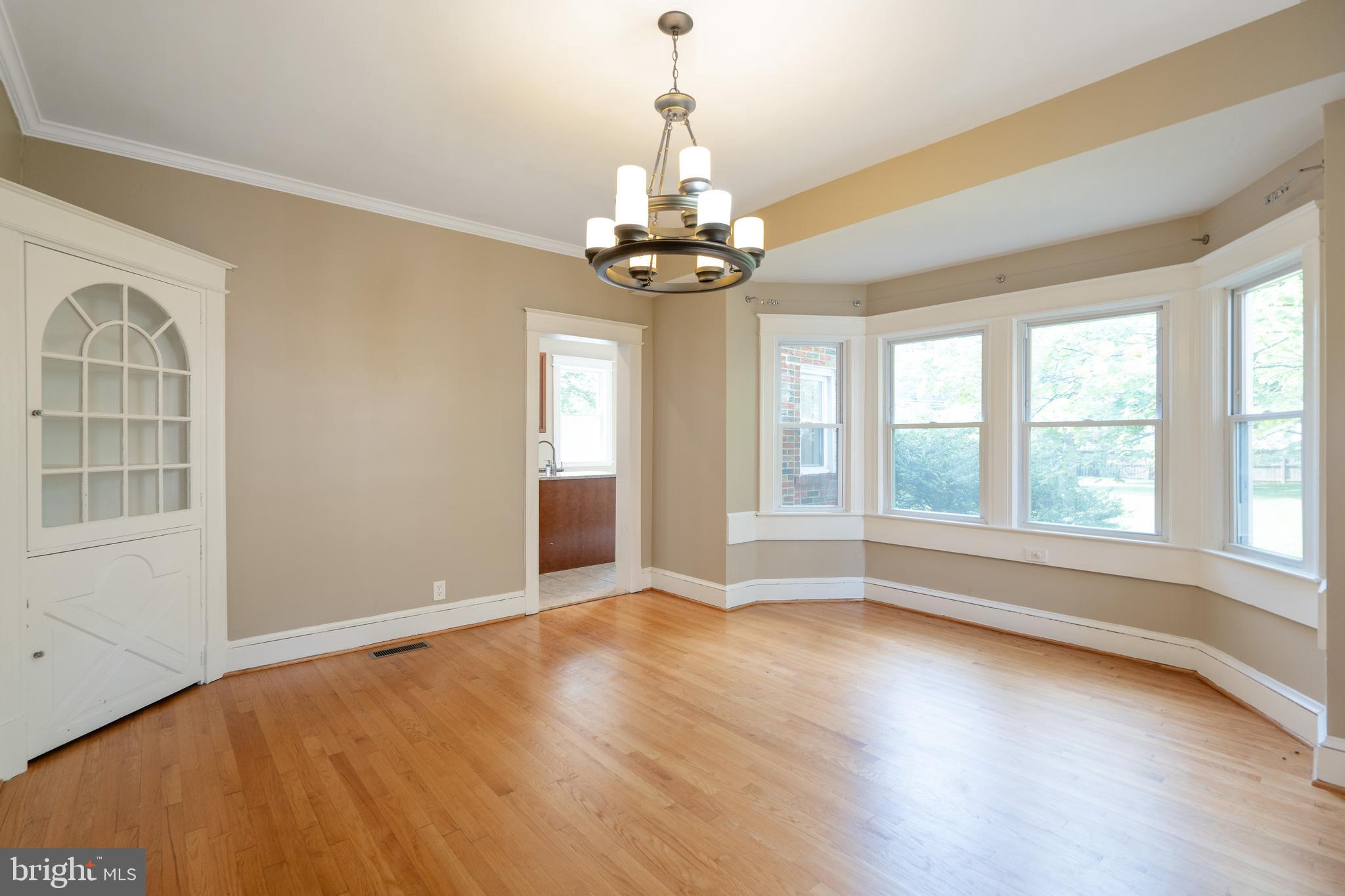 1955 Seminary Road Silver Spring, MD 20910 - Photo 9 of 41 a view of an empty room with wooden floor and a window