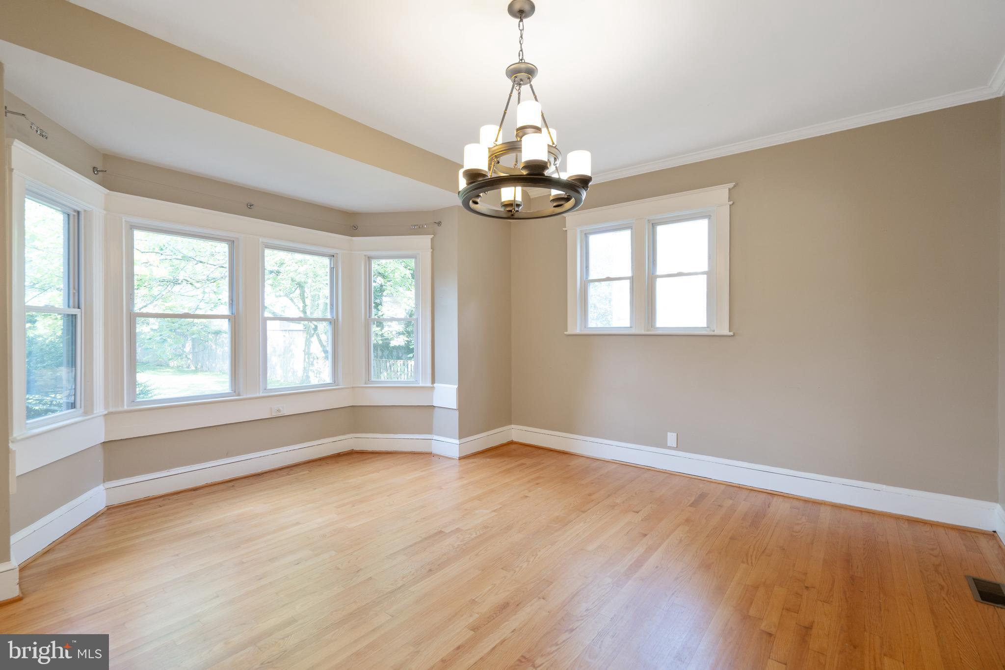 1955 Seminary Road Silver Spring, MD 20910 - Photo 10 of 41 a view of an empty room with wooden floor and a window