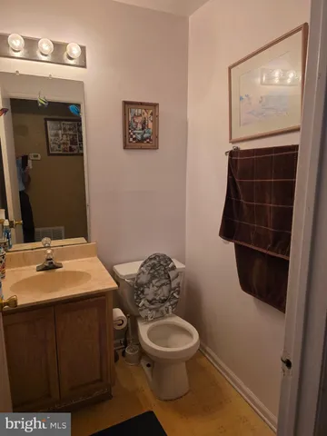 a bathroom with a toilet a sink and mirror