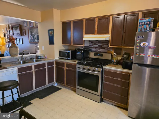 a kitchen with stainless steel appliances a stove and a refrigerator